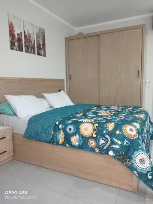 a bedroom with a bed with a blue blanket at luxury one bedroom at scandic resort in Hurghada