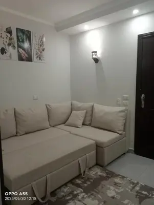 a couch in a room with a white wall at luxury one bedroom at scandic resort in Hurghada