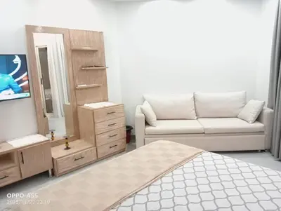 a bedroom with a bed and a mirror and a couch at luxury one bedroom at scandic resort in Hurghada