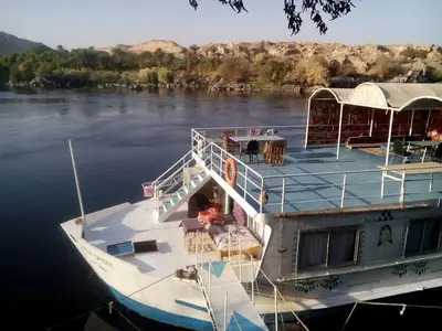 a boat is docked on the water at Shellaly Ca Nubian Guest2 House in Jazīrat Salūjah