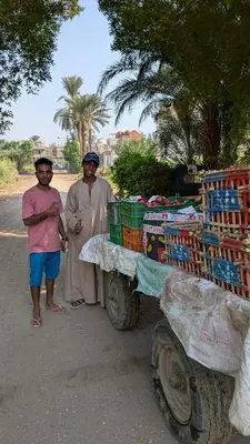 a couple of people standing next to a cart at 2 Karima house B in Al Aqālitah