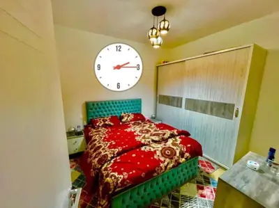 a bedroom with a bed with a large clock on the wall at Turtles beach resort in Hurghada