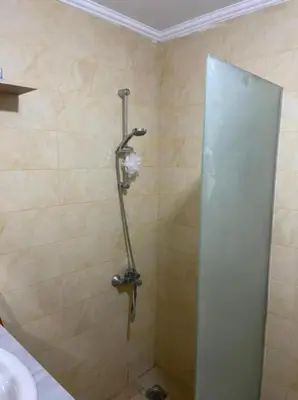 a shower stall in a bathroom with a sink at Turtles beach resort in Hurghada