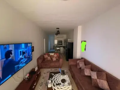 a living room with a large flat screen tv at Turtles beach resort in Hurghada