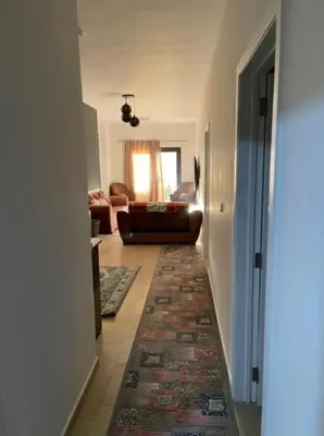 a hallway with a living room with a couch and a rug at Turtles beach resort in Hurghada