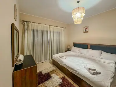 a bedroom with a large bed and a window at Decoraive Appartment AlDaU Hurghada in Sahl Hasheesh