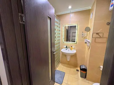a bathroom with a sink and a toilet and a mirror at Decoraive Appartment AlDaU Hurghada in Sahl Hasheesh