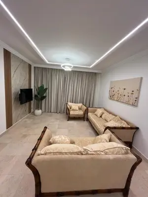 a living room with two couches and a tv at Sea front 2 bedrooms apartment in Esplanada in Hurghada