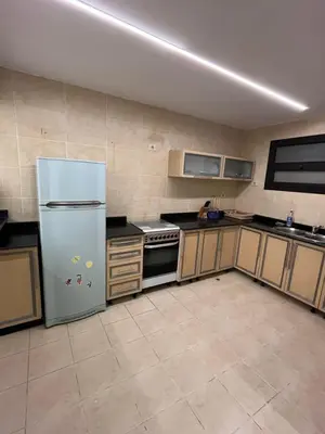 a large kitchen with a refrigerator and a stove at Sea front 2 bedrooms apartment in Esplanada in Hurghada