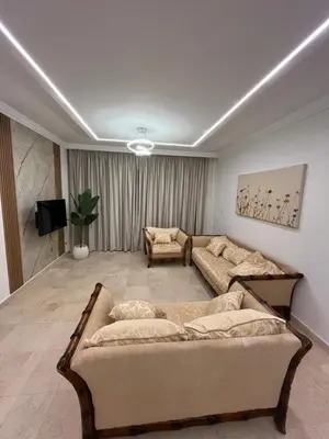 a living room with a couch and a tv at Sea front 2 bedrooms apartment in Esplanada in Hurghada