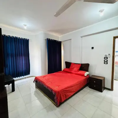a bedroom with a red bed and a mirror at Many hahaha in Luxor