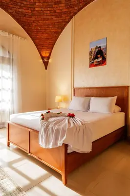 a bedroom with a bed with flowers on it at opal legacy luxor in Luxor