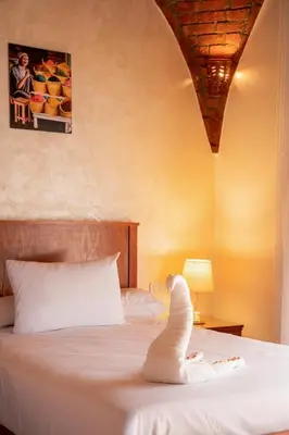 a stuffed animal is sitting on a bed at opal legacy luxor in Luxor