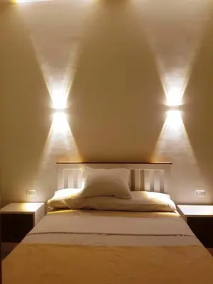 a bedroom with two lights above a bed at Malika House in Luxor