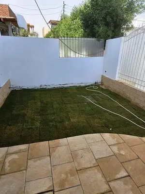 a backyard with a white fence and a basketball court at Malika House in Luxor