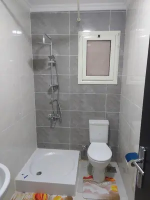 a small bathroom with a toilet and a sink at Hurghada Apartment with pool in Hurghada