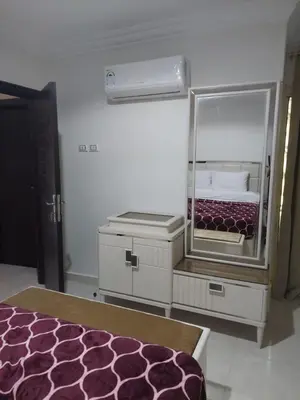 a bedroom with a mirror and a bed in it at Hurghada Apartment with pool in Hurghada