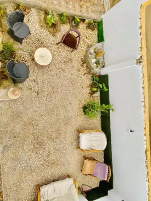 an overhead view of the sand with shoes and plants at Alena guest house in Jazīrat al ‘Awwāmīyah