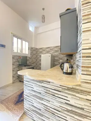 a kitchen with a counter with a kettle on it at Alena guest house in Jazīrat al ‘Awwāmīyah