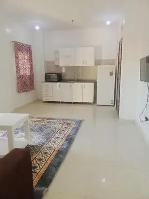 a living room with a kitchen and a refrigerator at Cozy 2-Bedroom Apartment Ramla, West Bank, Luxor in Luxor
