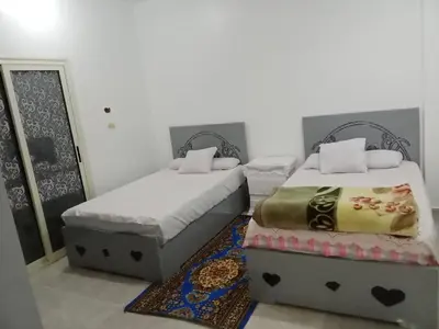two beds sitting next to each other in a bedroom at Cozy 2-Bedroom Apartment Ramla, West Bank, Luxor in Luxor