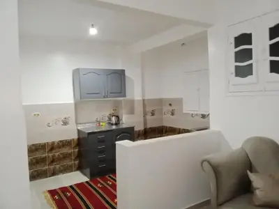 a kitchen with a sink and a couch in a room at Cozy 2-Bedroom Apartment Ramla, West Bank, Luxor in Luxor