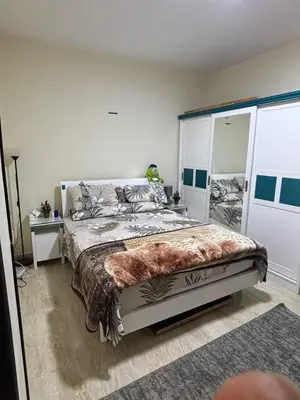 a bedroom with a large bed and a mirror at El nour in Hurghada