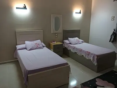 two beds in a small room with at noreno guest house in Aswan