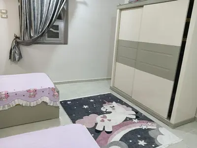 a room with a rug with a unicorn on it at noreno guest house in Aswan
