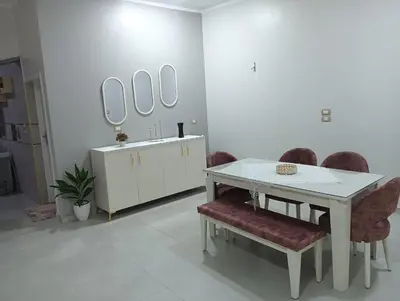 a bathroom with a table and chairs and mirrors at noreno guest house in Aswan