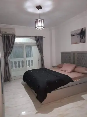 a bedroom with a bed with a black blanket on it at Private villa with swimming pool in Hurghada