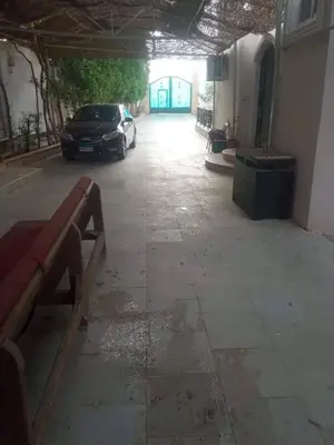 a car parked in a parking lot next to a building at Private villa with swimming pool in Hurghada