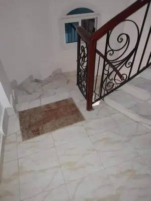 a staircase with a iron railing and a tile floor at Private villa with swimming pool in Hurghada