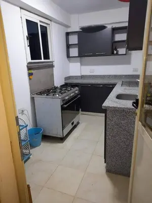 an empty kitchen with a stove and a sink at Private villa with swimming pool in Hurghada