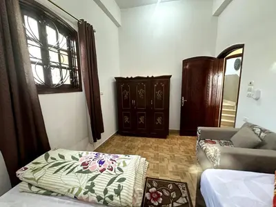 a living room with a couch and a window at Garden Level Oasis Near Nile in Luxor