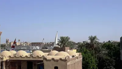 a building with domes on top of it next to a harbor at Garden Level Oasis Near Nile in Luxor