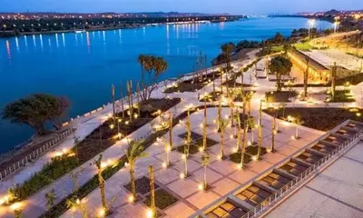 an aerial view of a park next to the water at night at شركةستار للخدمات السياحيه in Aswān