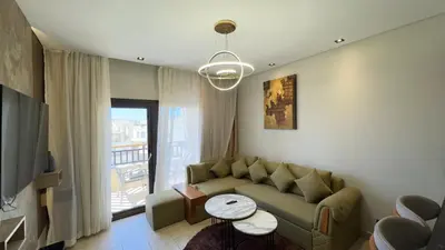 a living room with a couch and a table at Galaxy Aldau Hieghts in Hurghada