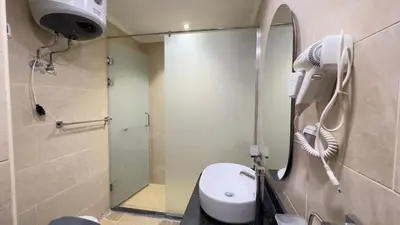a bathroom with a shower and a toilet with a hair dryer at Galaxy Aldau Hieghts in Hurghada