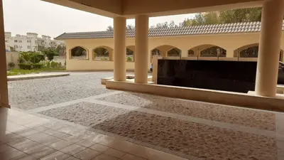 a courtyard with a large building with columns at Galaxy Aldau Hieghts in Hurghada