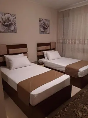 a bedroom with two beds and a window at Mangarove m3 1c 11 in Hurghada