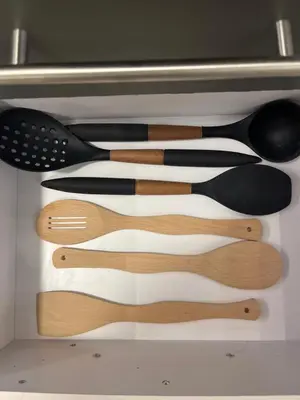 a drawer filled with lots of wooden utensils at Benashti Hurghada apartment in Hurghada