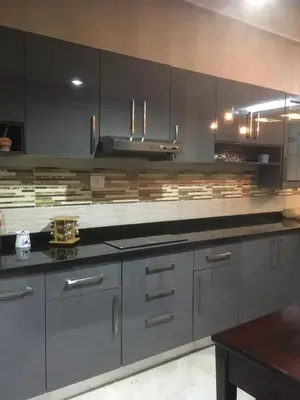 a kitchen with gray cabinets and a stove top oven at House of Hathor in Luxor