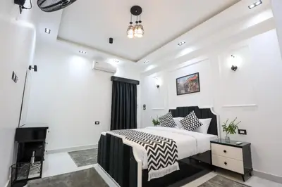a bedroom with a king sized bed and a fireplace at Elbakry Hotel Luxor in Luxor