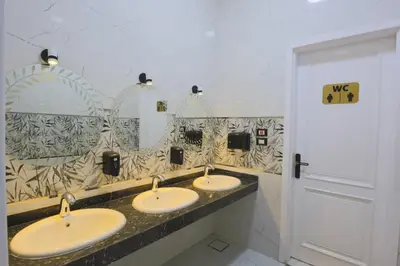 a bathroom with three sinks and a mirror at Elbakry Hotel Luxor in Luxor