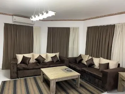 a living room with a couch and a coffee table at Regency Towers Apartments in Hurghada