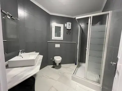 a bathroom with a shower and a sink and a toilet at Regency Towers Apartments in Hurghada
