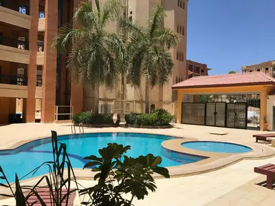 a swimming pool in the middle of a building at Regency Towers Apartments in Hurghada
