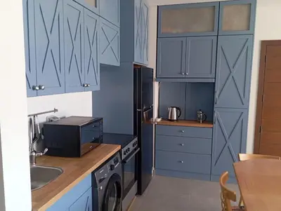 a kitchen with blue cabinets and a sink at Charment Chalet Somabay in Hurghada