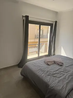 a bedroom with a bed and a large window at 304 aqua blue bay in Hurghada